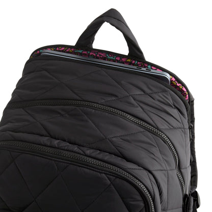 Black quilted backpack with floral interior lining on a white background
