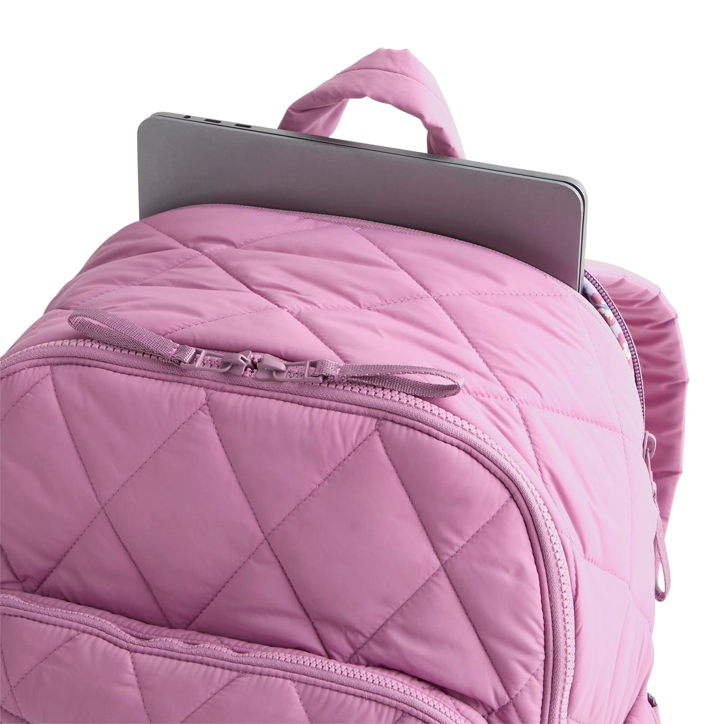 Pink quilted backpack with a tablet on a white background